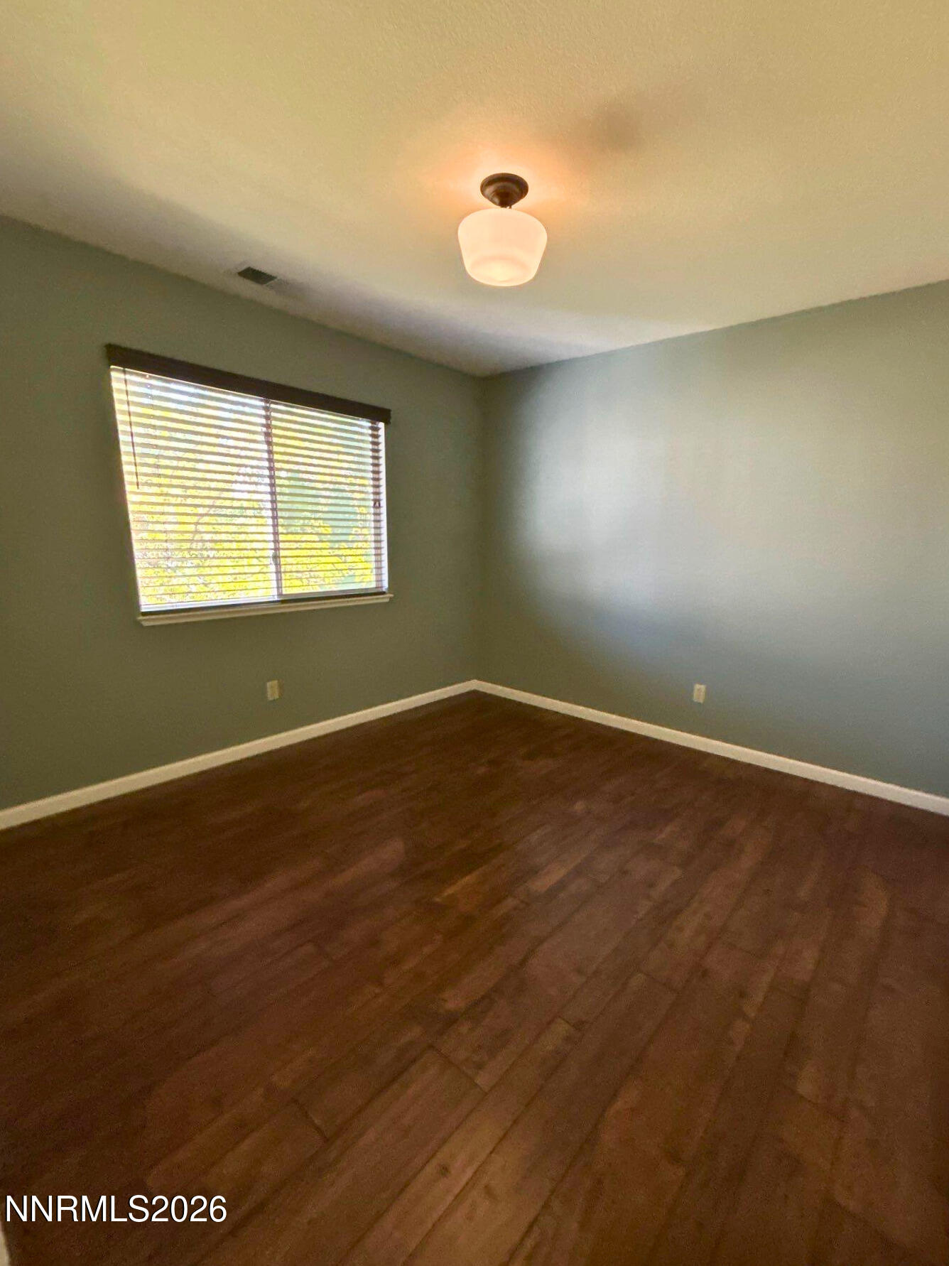 4437 Highplains Drive Reno, NV 89523 - Photo 16 of 19 an empty room with wooden floor and windows