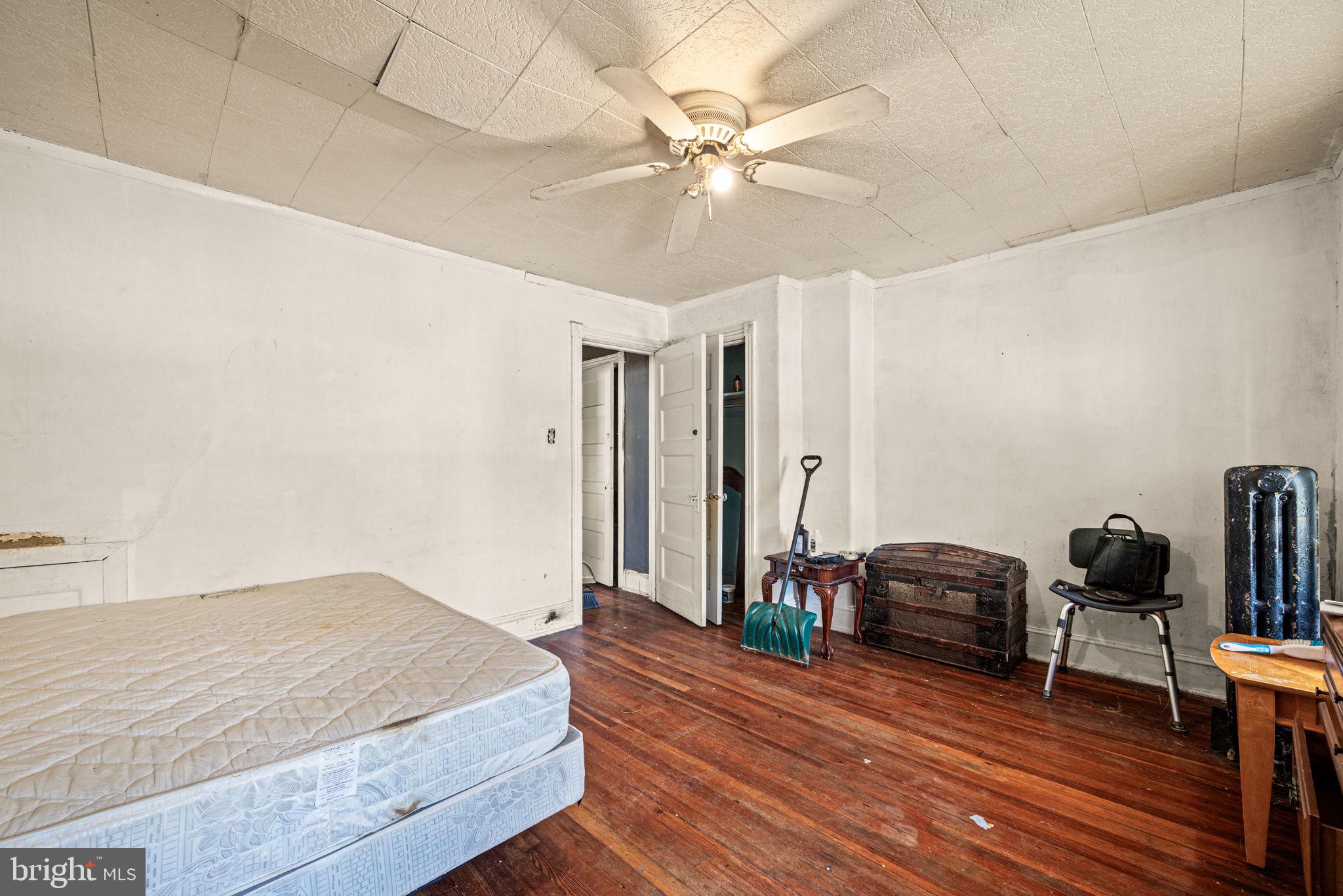 102 West Cliveden Street Philadelphia, PA 19119 - Photo 12 of 25 a bedroom with a bed and a chandelier