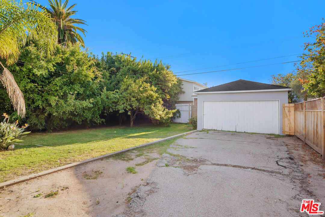 3701 Tilden Avenue Los Angeles, CA 90034 - Photo 15 of 29 a front view of a house with a yard and garage