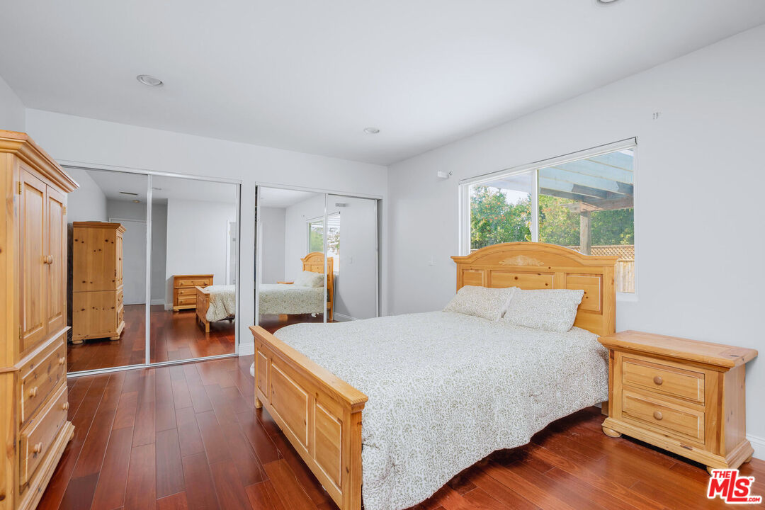 3701 Tilden Avenue Los Angeles, CA 90034 - Photo 16 of 29 a bedroom with a bed and wooden floor