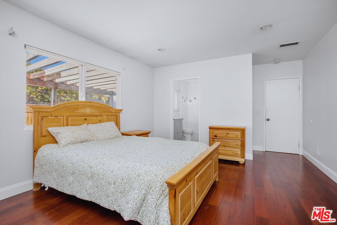 3701 Tilden Avenue Los Angeles, CA 90034 - Photo 17 of 29 a bedroom with a bed and wooden floor
