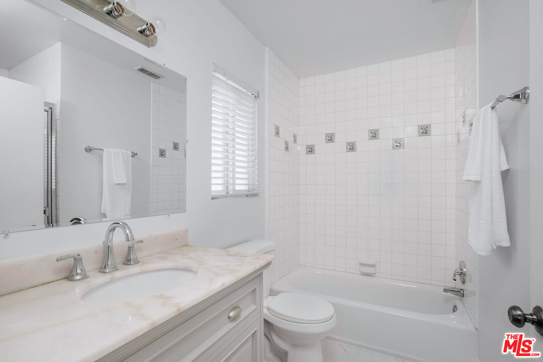 3701 Tilden Avenue Los Angeles, CA 90034 - Photo 18 of 29 a bathroom with a granite countertop sink toilet and shower