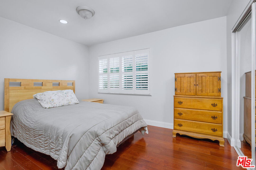 3701 Tilden Avenue Los Angeles, CA 90034 - Photo 19 of 29 a bedroom with a bed and wooden floor