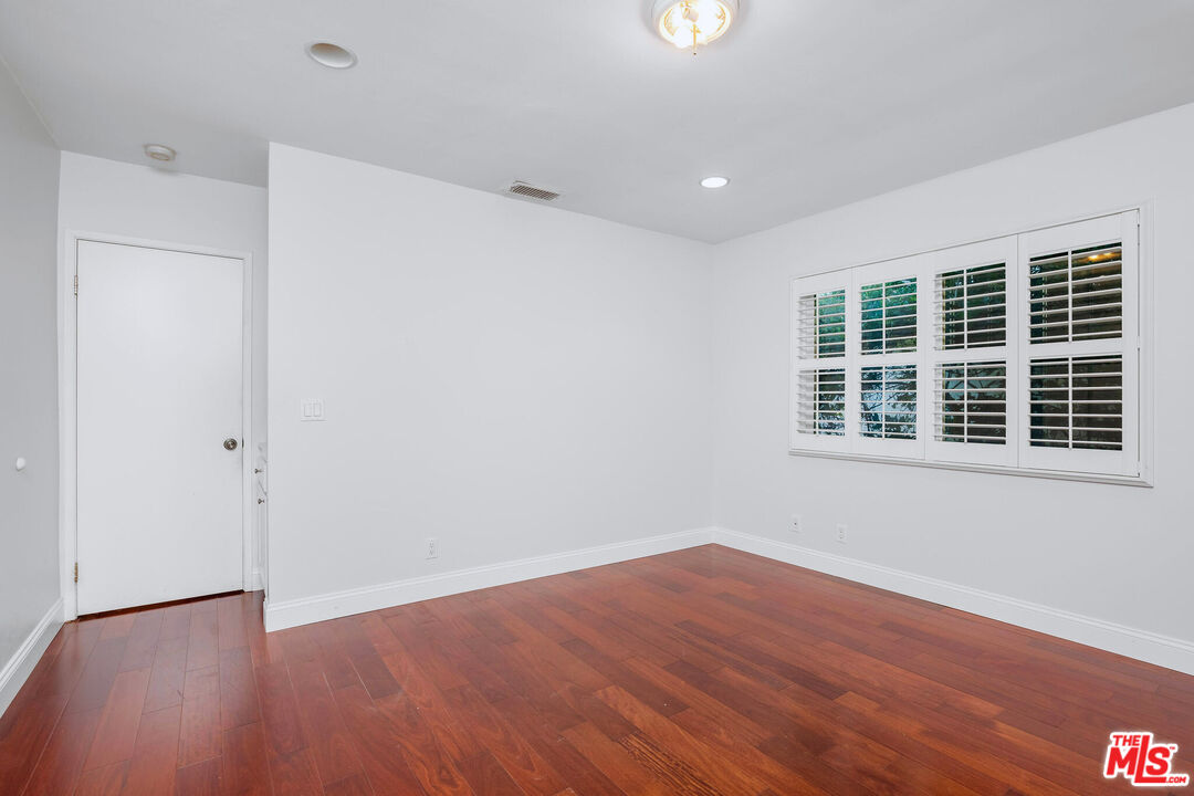 3701 Tilden Avenue Los Angeles, CA 90034 - Photo 22 of 29 an empty room with wooden floor and windows