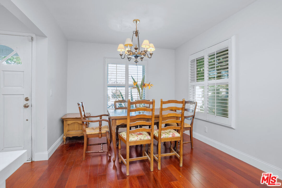 3701 Tilden Avenue Los Angeles, CA 90034 - Photo 7 of 29 a view of a dining room with furniture wooden floor and chandelier