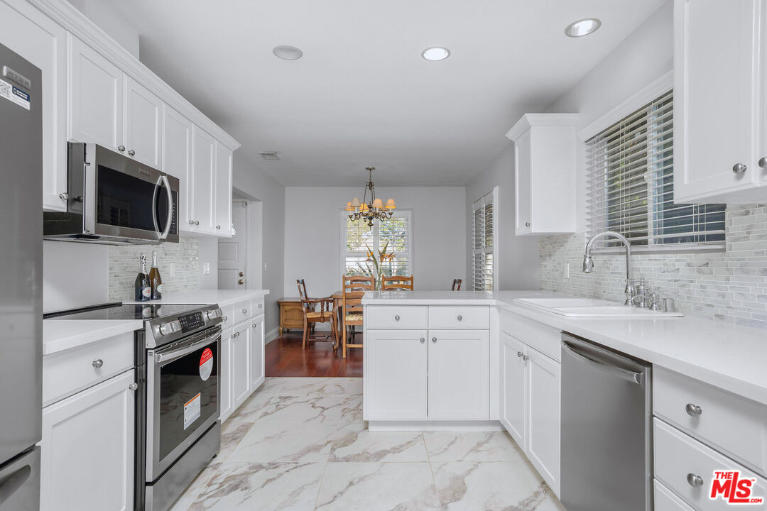 3701 Tilden Avenue Los Angeles, CA 90034 - Photo 8 of 29 a kitchen with a sink stove and microwave