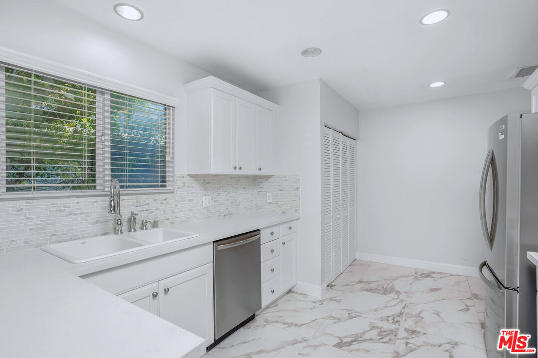 3701 Tilden Avenue Los Angeles, CA 90034 - Photo 10 of 29 a kitchen with a sink cabinets and refrigerator