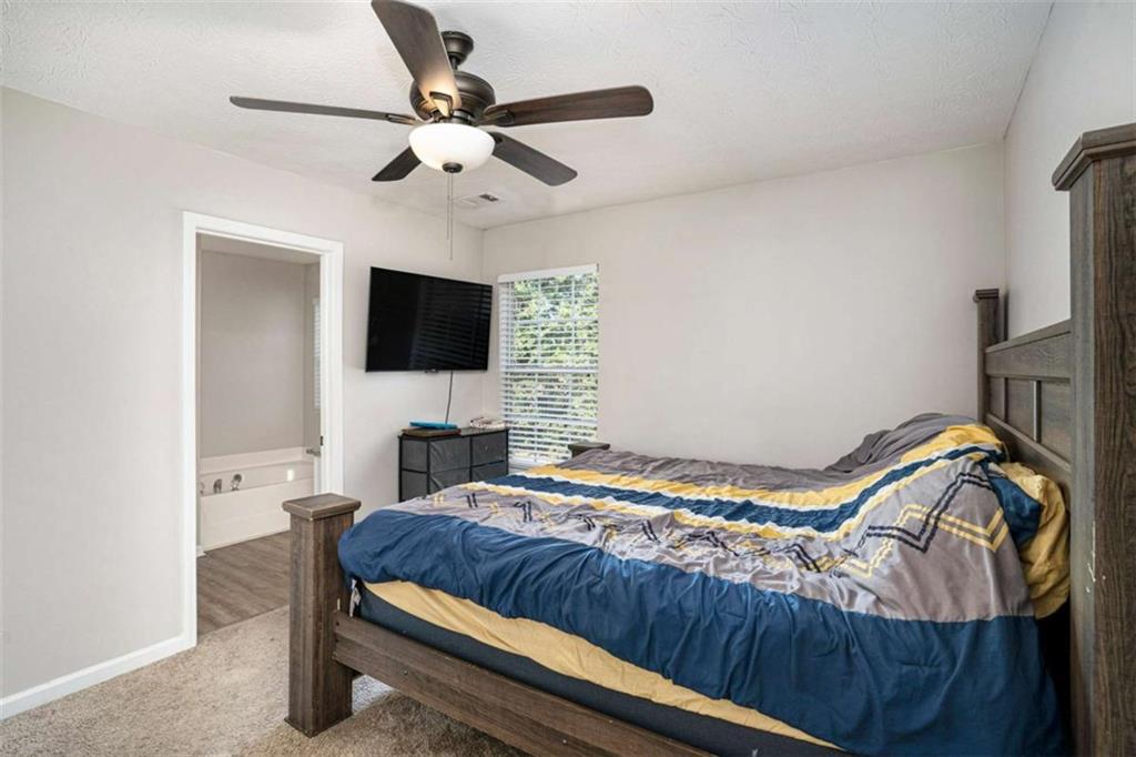 1120 Labonte Parkway McDonough, GA 30253 - Photo 13 of 22 a bedroom with a bed and a flat screen tv