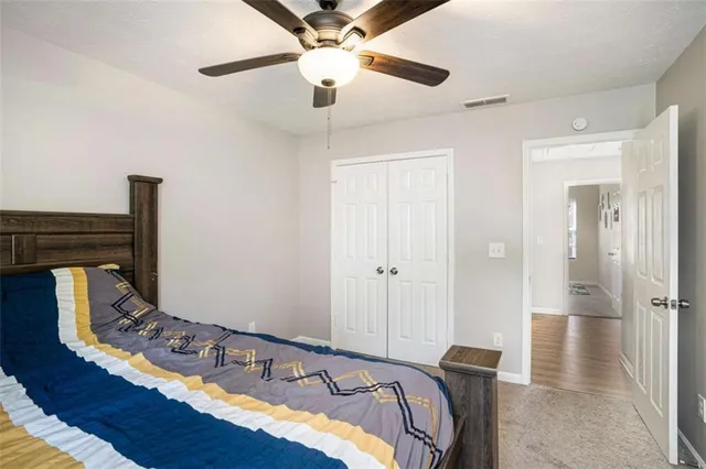 a bedroom with bed and wooden floor