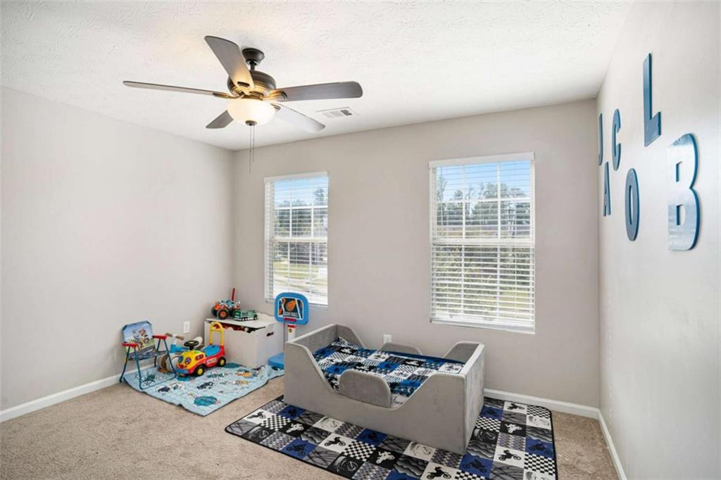 1120 Labonte Parkway McDonough, GA 30253 - Photo 18 of 22 a bedroom with furniture and a window