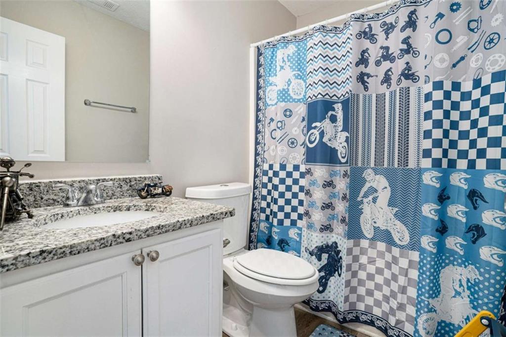 1120 Labonte Parkway McDonough, GA 30253 - Photo 20 of 22 a bathroom with a granite countertop toilet sink and mirror