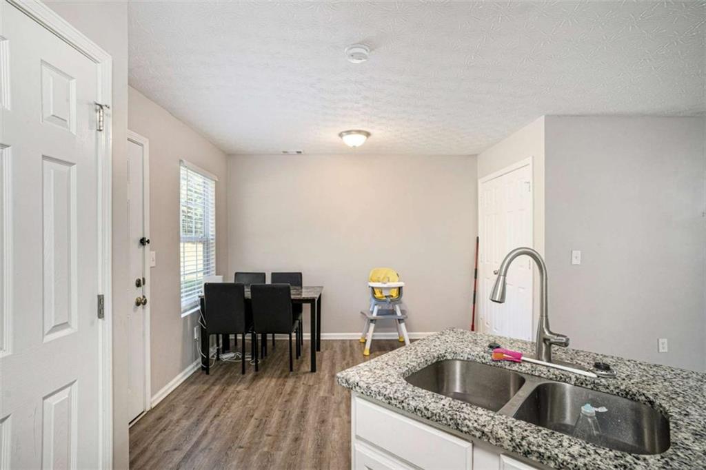 1120 Labonte Parkway McDonough, GA 30253 - Photo 8 of 22 a kitchen with a sink cabinets and dining table