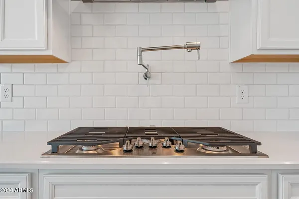 a stove top oven sitting inside of a kitchen