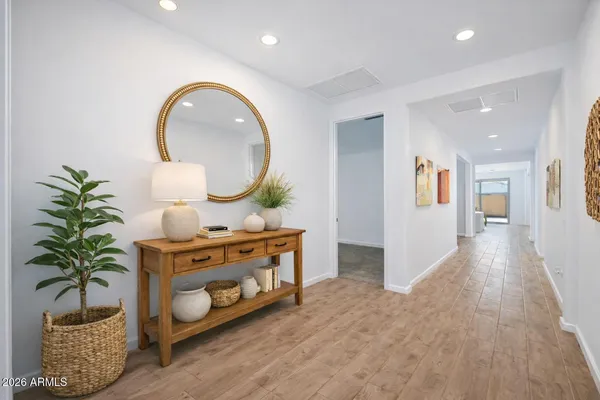 a view of a bedroom with wooden floor and a potted plant