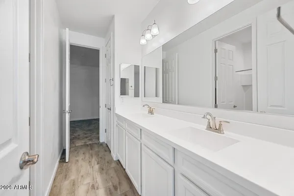 a bathroom with a double vanity sink and a mirror