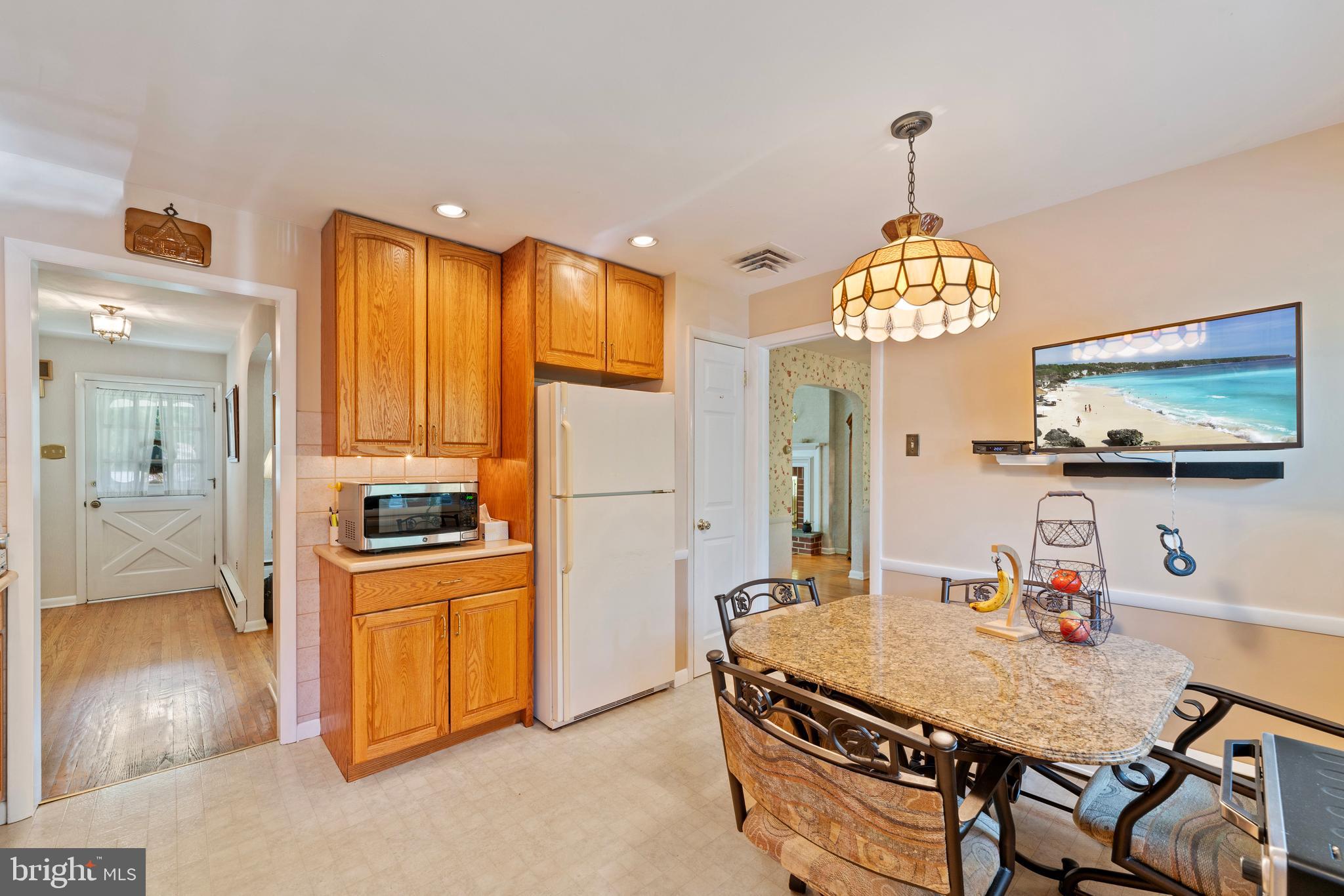 1131 Frederick Road Jenkintown, PA 19046 - Photo 11 of 30 a room with stainless steel appliances granite countertop a sink dishwasher and a dining table with garden view