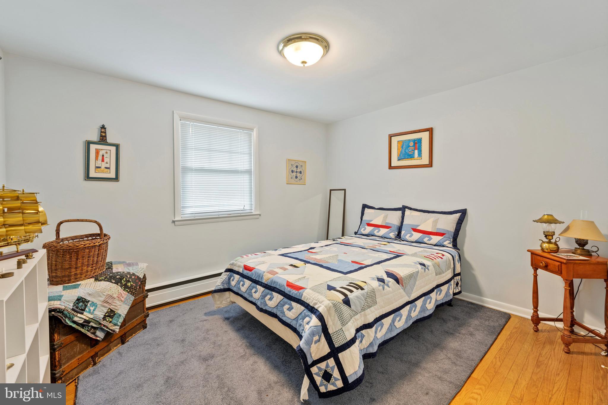 1131 Frederick Road Jenkintown, PA 19046 - Photo 18 of 30 a bedroom with a bed and wooden floor