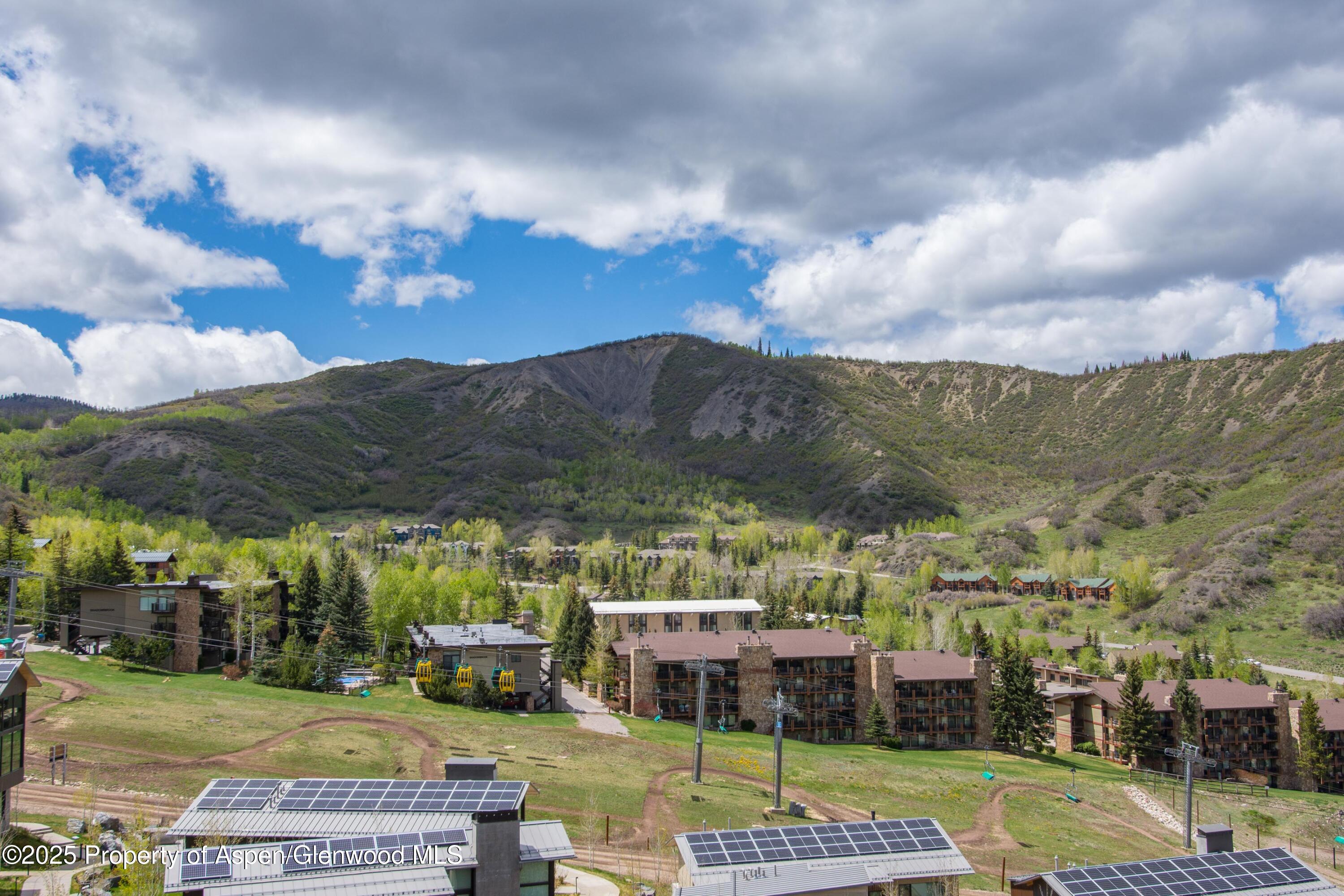 425 Wood Road, Unit 48 Snowmass Village, CO 81615 - Photo 14 of 41 a view of a swimming pool and a yard