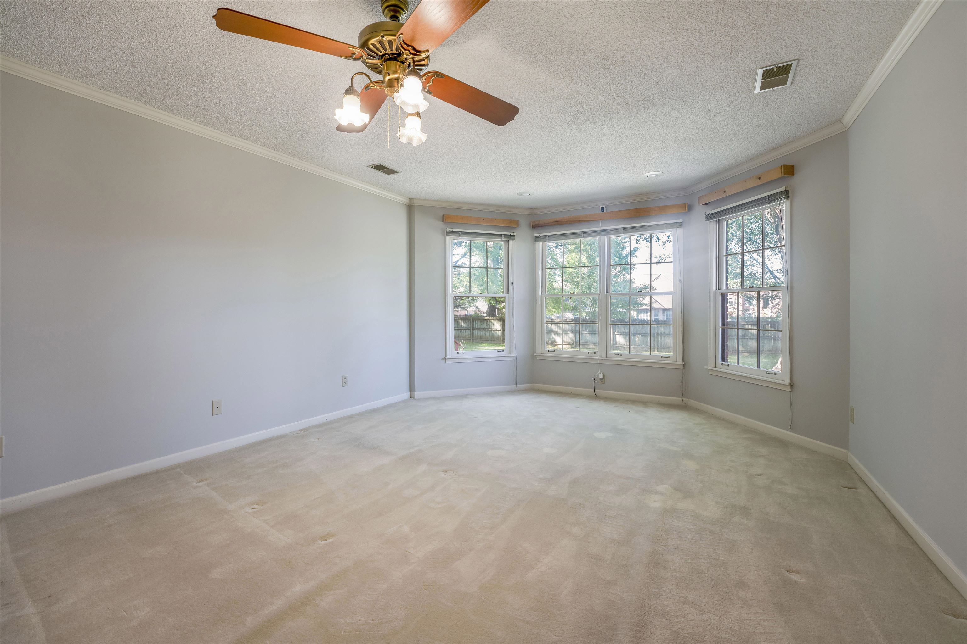8497 Bazemore Road Memphis, TN 38018 - Photo 15 of 16 an empty room with windows and fan