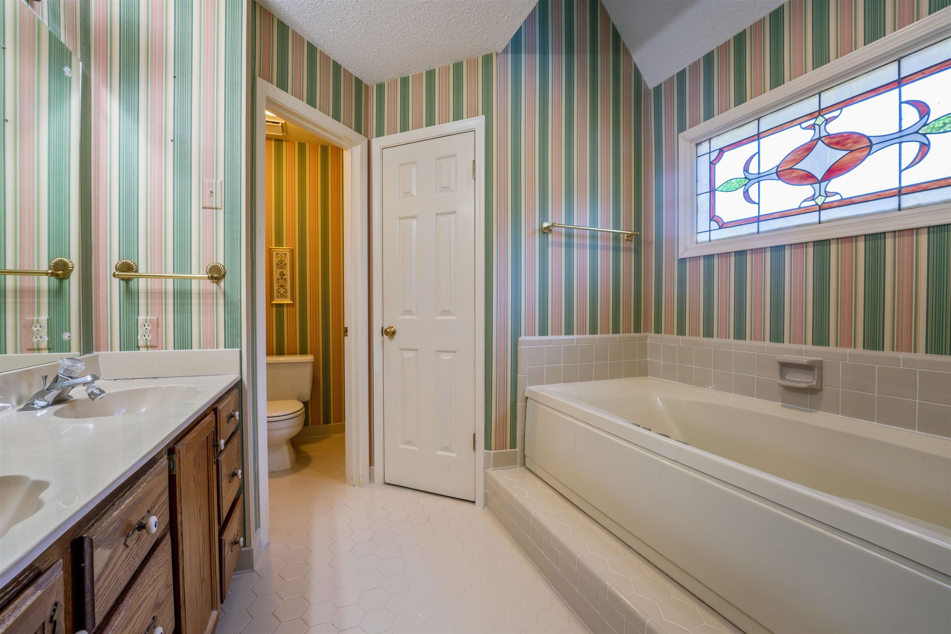 8497 Bazemore Road Memphis, TN 38018 - Photo 16 of 16 a spacious bathroom with a tub a sink and a large window