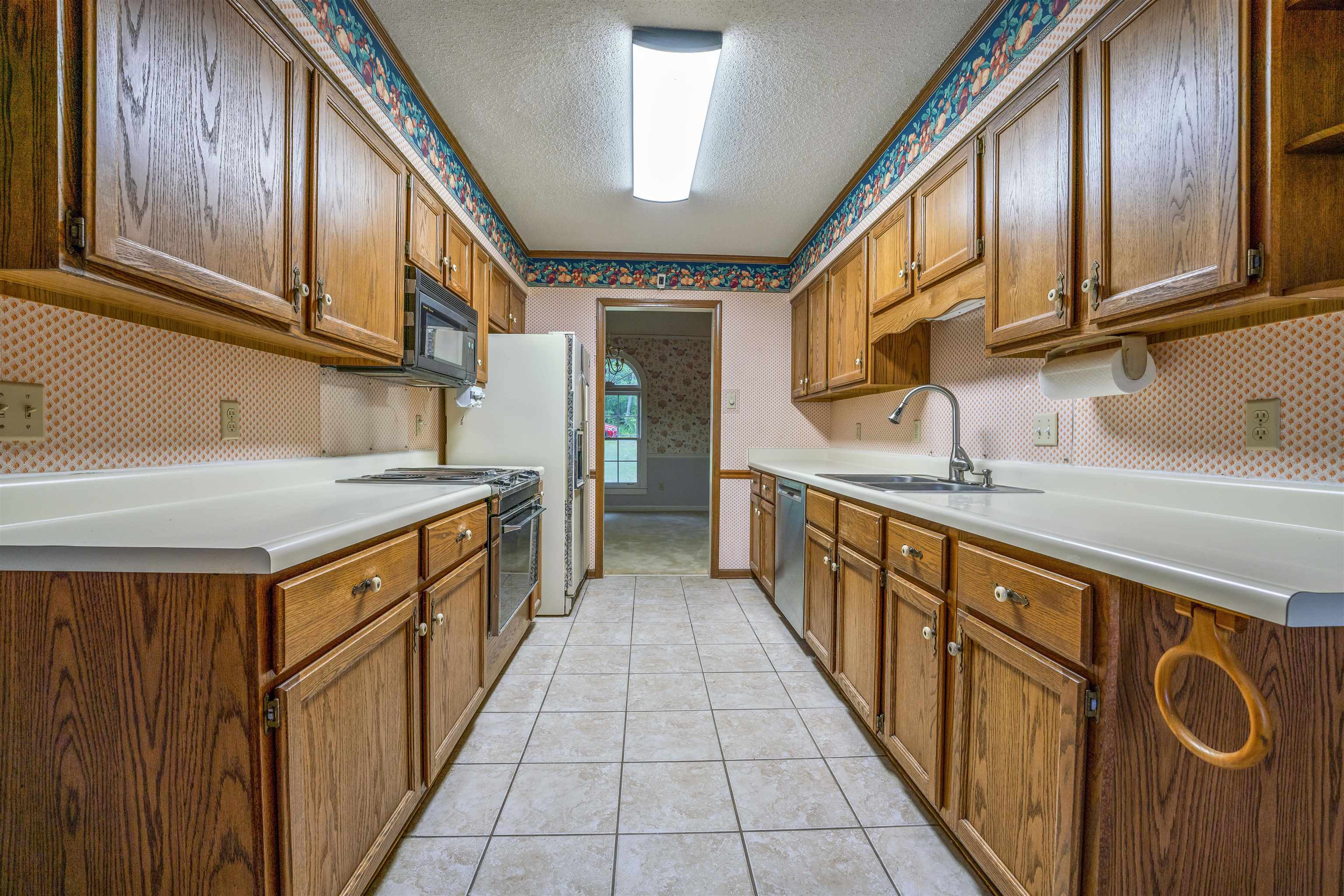 8497 Bazemore Road Memphis, TN 38018 - Photo 5 of 16 a kitchen with stainless steel appliances granite countertop a sink and cabinets