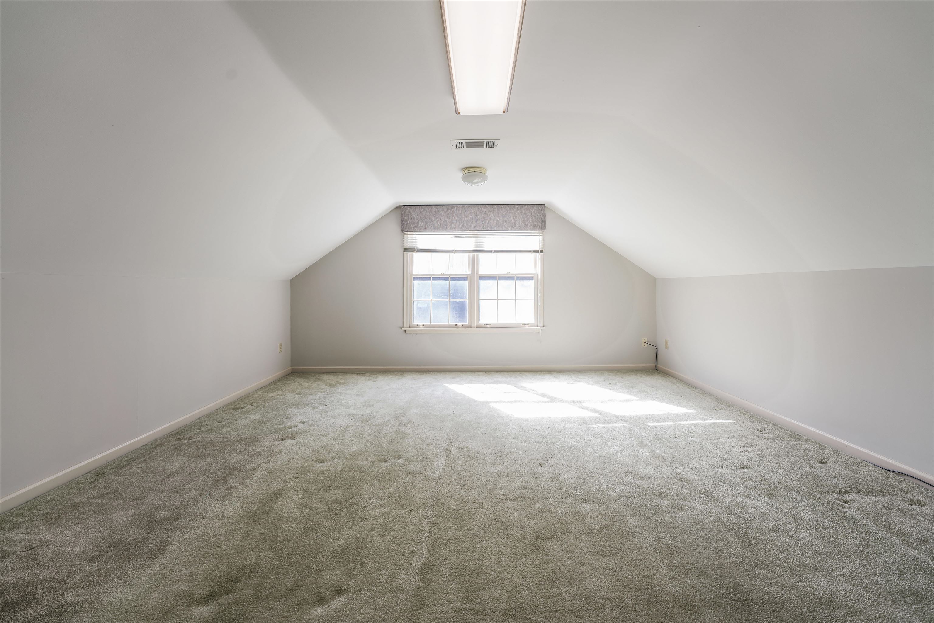 8497 Bazemore Road Memphis, TN 38018 - Photo 7 of 16 an empty room with a window and a fireplace