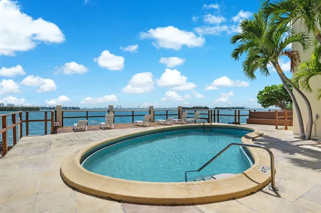 a view of a swimming pool with a table and chairs