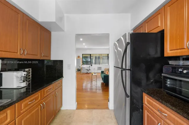 a kitchen with stainless steel appliances granite countertop a refrigerator stove and a sink