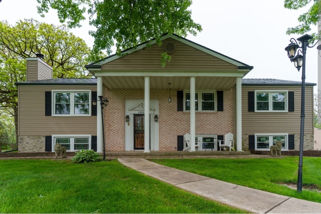 24804 South Oak Lane Crete, IL 60417 - Photo 1 of 1 a front view of a house with a yard