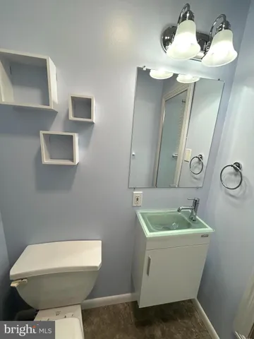 a bathroom with a sink mirror and toilet