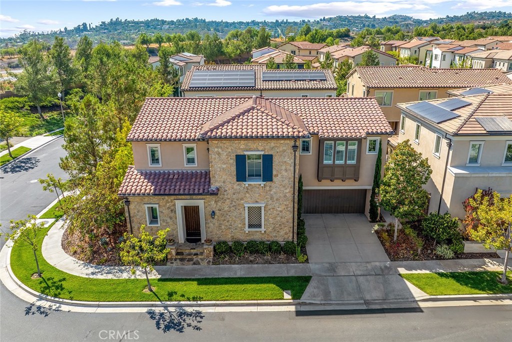 77 English Saddle Irvine, CA 92602 - Photo 1 of 35 a front view of a house with a yard table and chairs