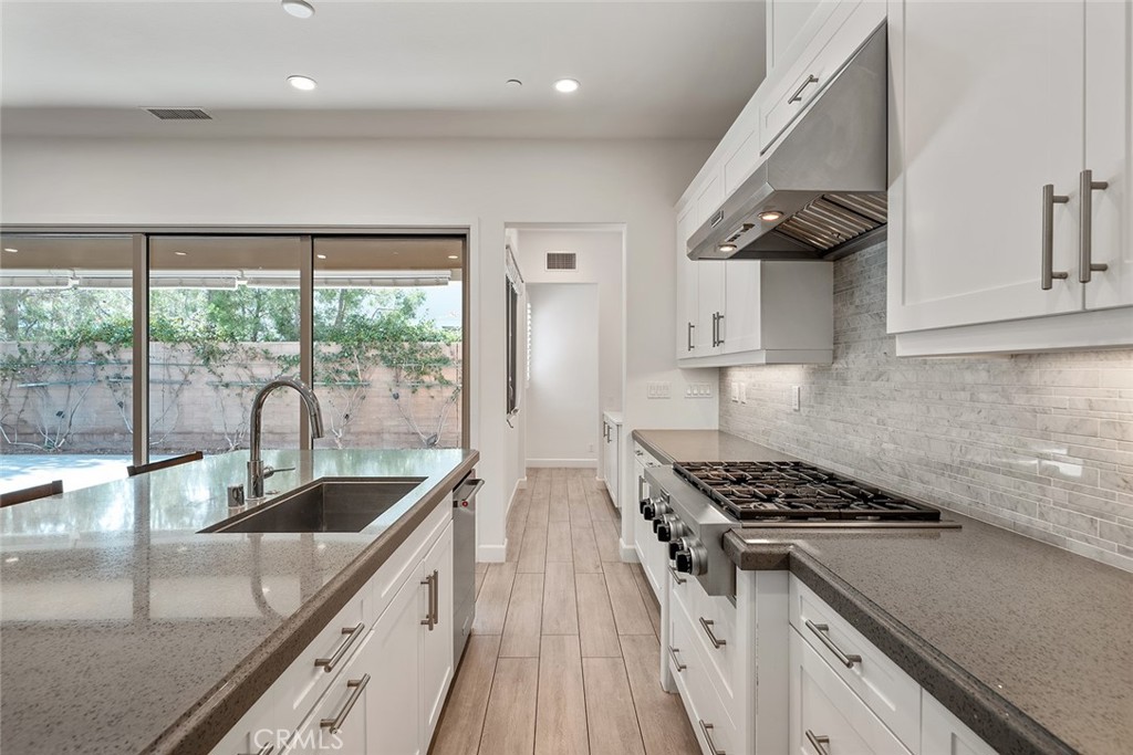 77 English Saddle Irvine, CA 92602 - Photo 15 of 35 a kitchen with stainless steel appliances granite countertop a sink stove and cabinets