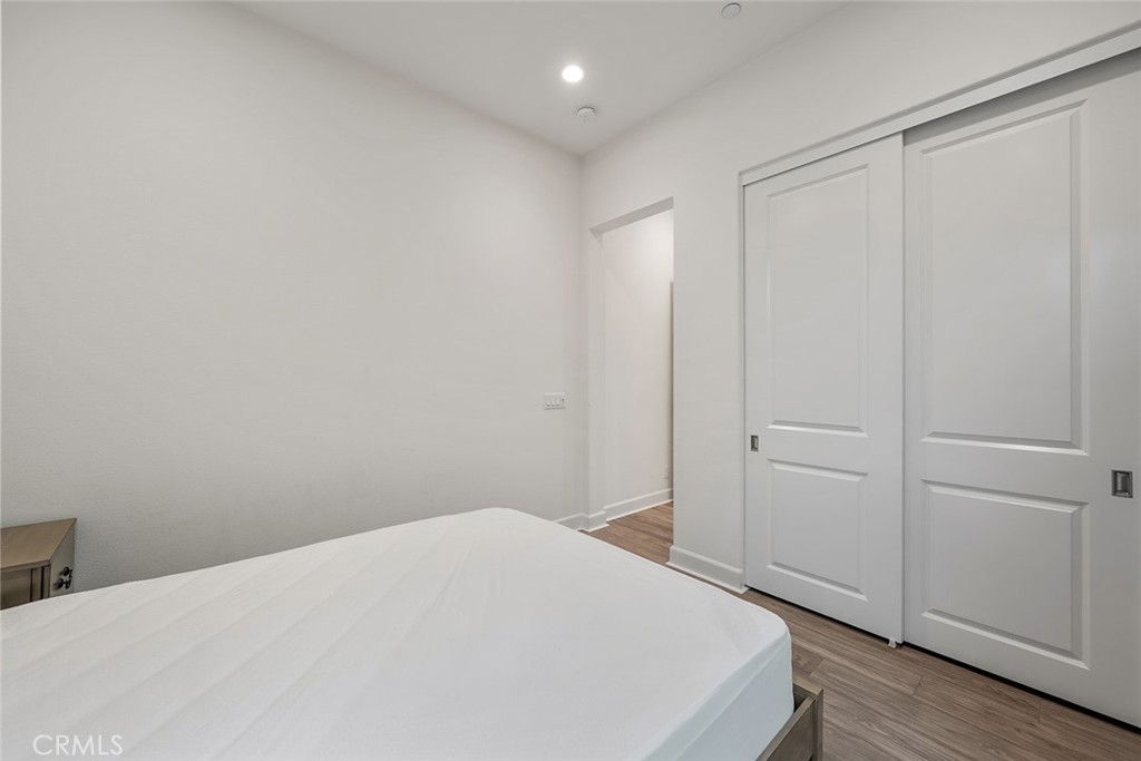 77 English Saddle Irvine, CA 92602 - Photo 18 of 35 a bedroom with a bed and wooden floor