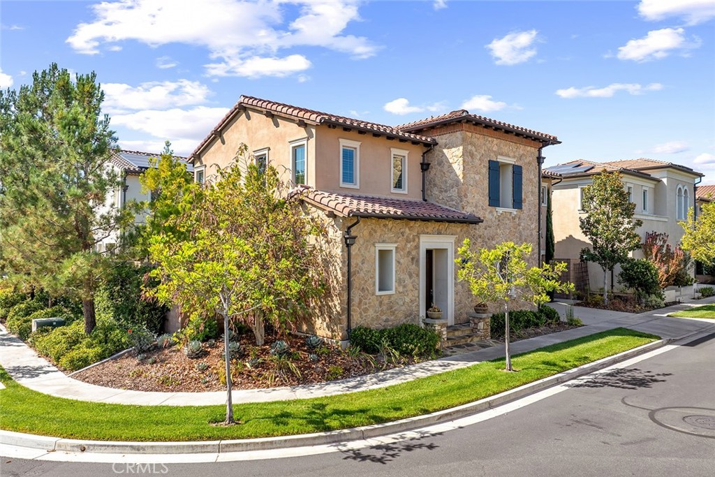 77 English Saddle Irvine, CA 92602 - Photo 2 of 35 a front view of a house with a yard and potted plants