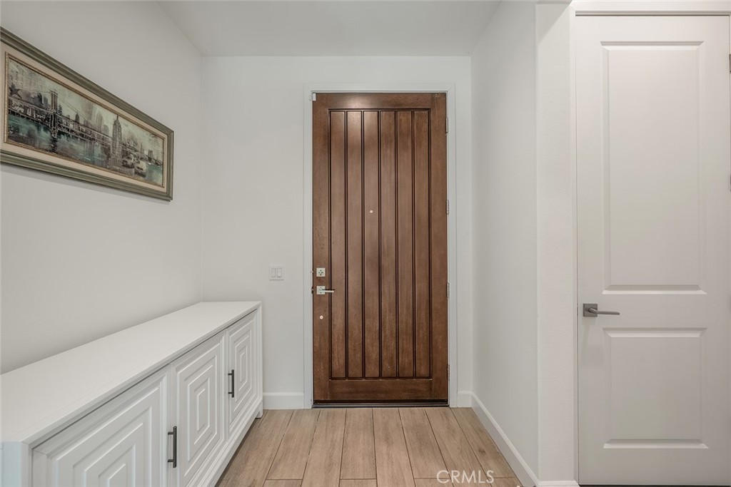 77 English Saddle Irvine, CA 92602 - Photo 21 of 35 a view of a hallway with wooden floor and entryway
