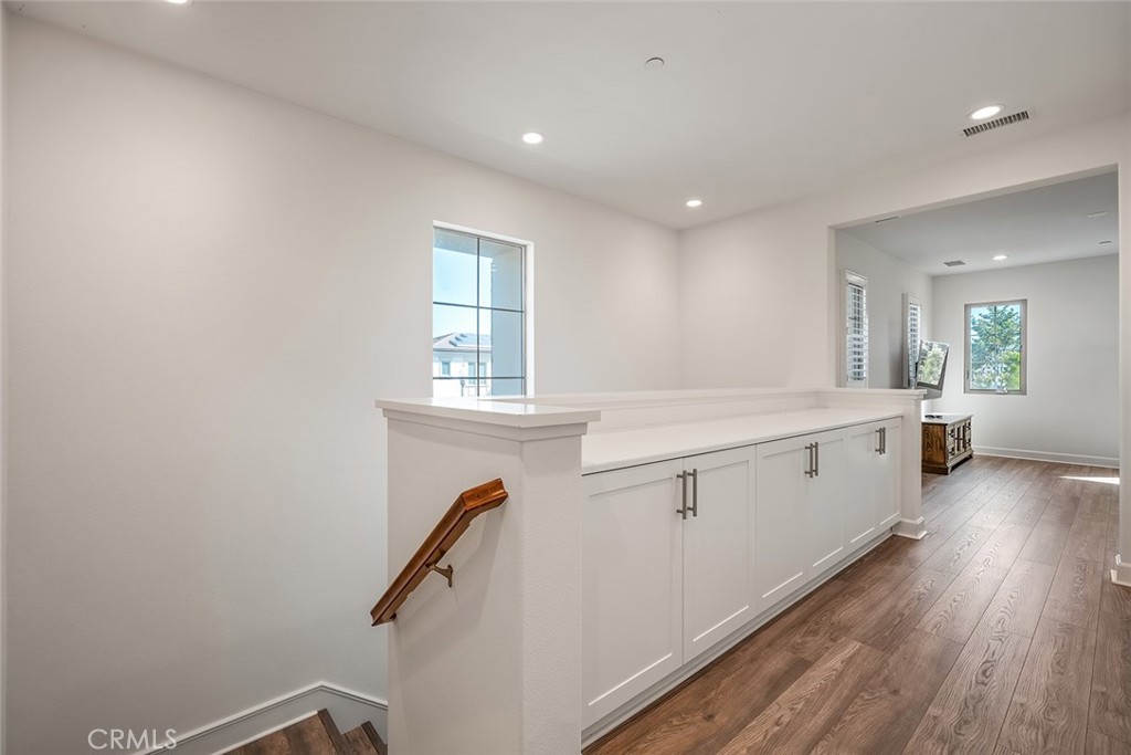 77 English Saddle Irvine, CA 92602 - Photo 22 of 35 a view of a kitchen with a sink and wooden floor