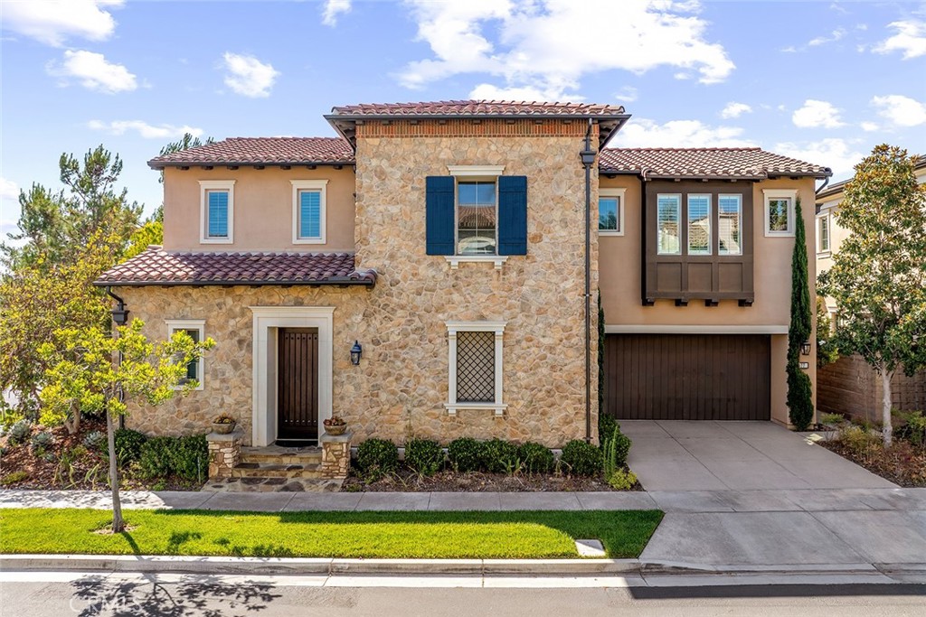 77 English Saddle Irvine, CA 92602 - Photo 3 of 35 a front view of a house with garden