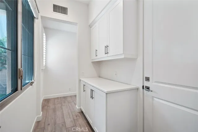 a view of a room with wooden floor
