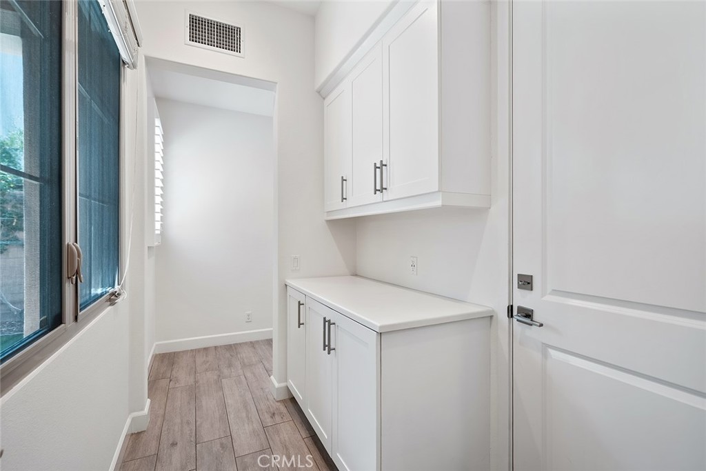 77 English Saddle Irvine, CA 92602 - Photo 31 of 35 a view of cabinets with wooden floor