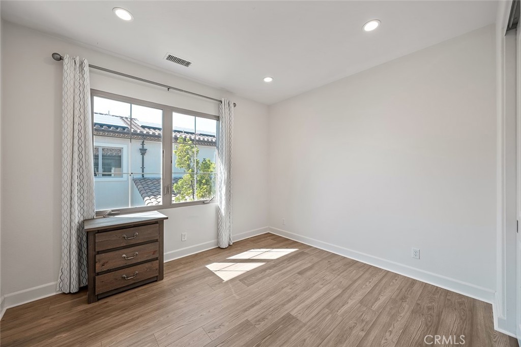 77 English Saddle Irvine, CA 92602 - Photo 32 of 35 an empty room with wooden floor and windows