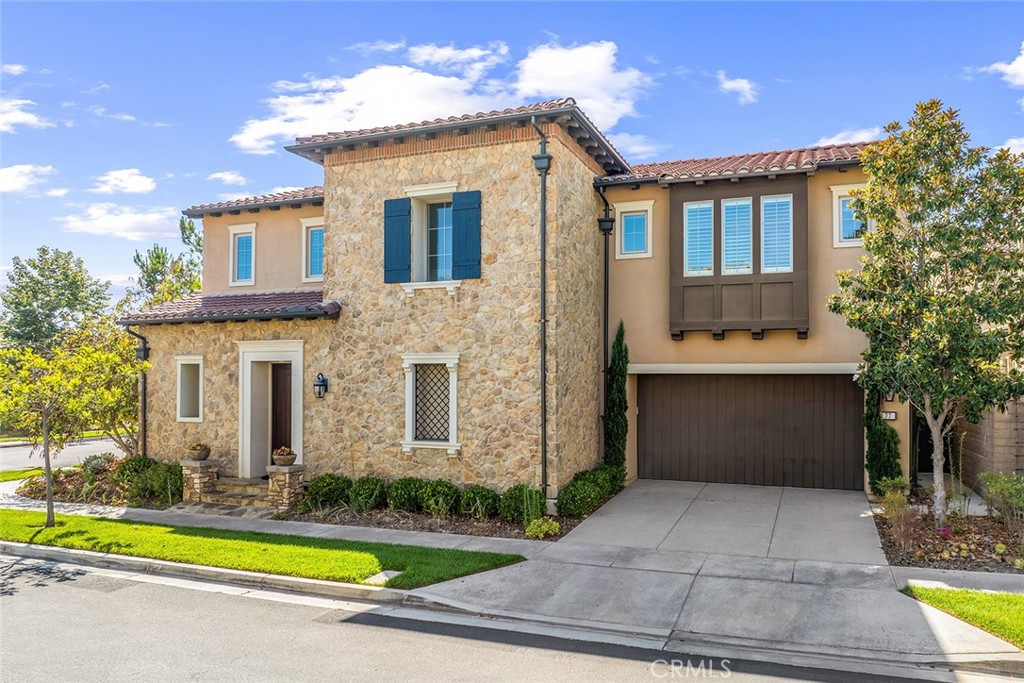 77 English Saddle Irvine, CA 92602 - Photo 4 of 35 a front view of a house with a yard and garage