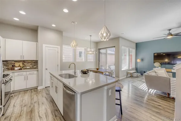 a kitchen with sink stove and cabinets