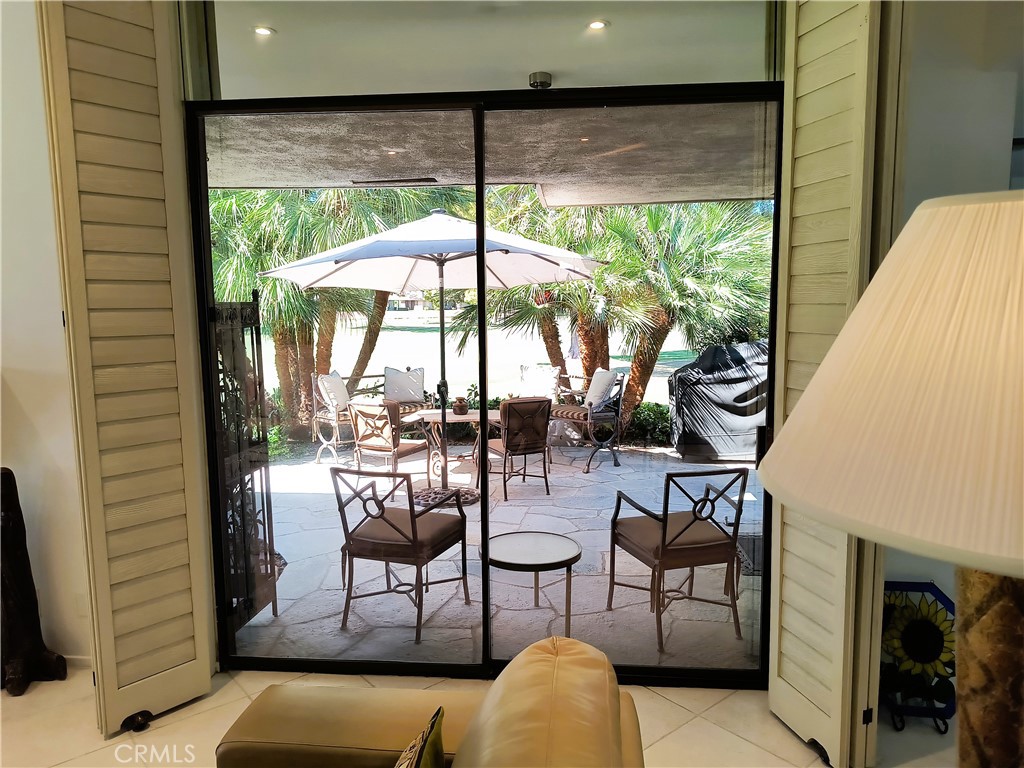 6 Whittier Court Rancho Mirage, CA 92270 - Photo 31 of 74 a living room with furniture and a floor to ceiling window