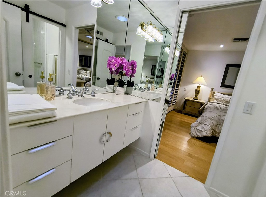 6 Whittier Court Rancho Mirage, CA 92270 - Photo 32 of 74 a bathroom with a granite countertop sink a mirror and vanity