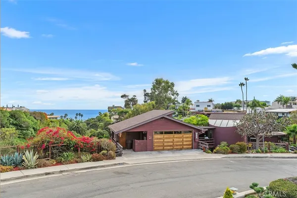 a house with a yard and wooden fence