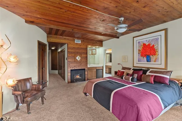 a spacious bedroom with two beds and a fireplace