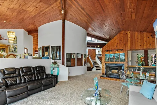 a living room with furniture a fireplace and a table