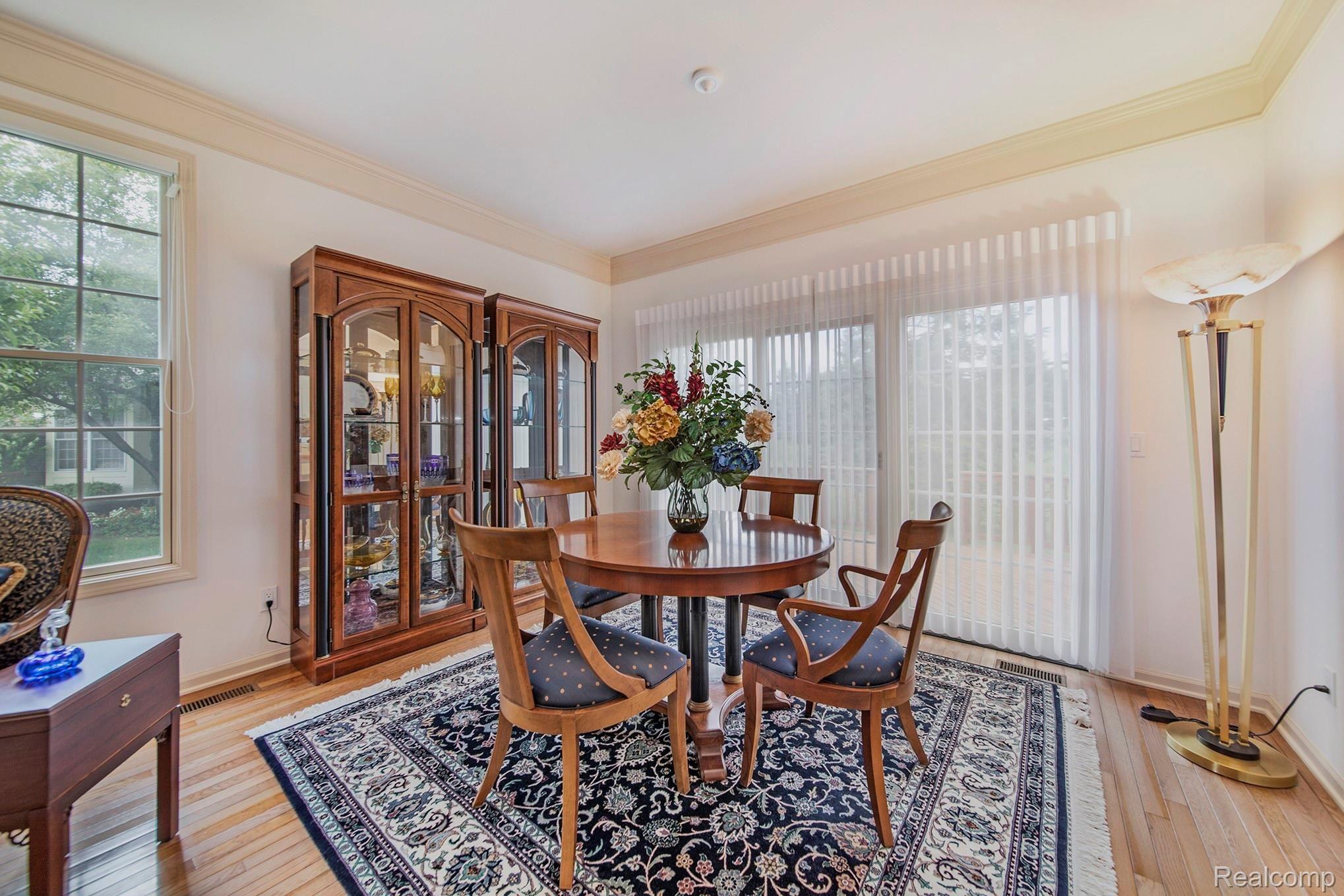 1379 Copper Circle, Unit 35 Rochester, MI 48306 - Photo 17 of 47 PELLA SLIDING DOOR IN DINING RM,OVERLOOKING THE COURTYARD. LOVELYSILHOUETTE VERTICAL SHADES.