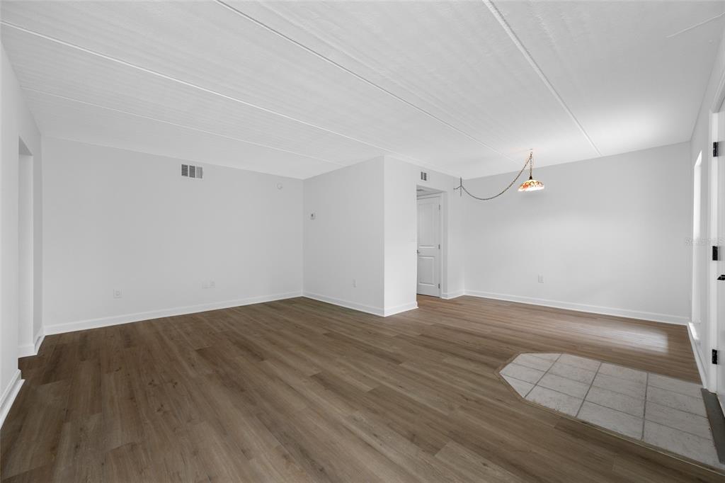 8911 Blind Pass Road, Unit 114 St. Pete Beach, FL 33706 - Photo 17 of 43 a view of an empty room with wooden floor and a window