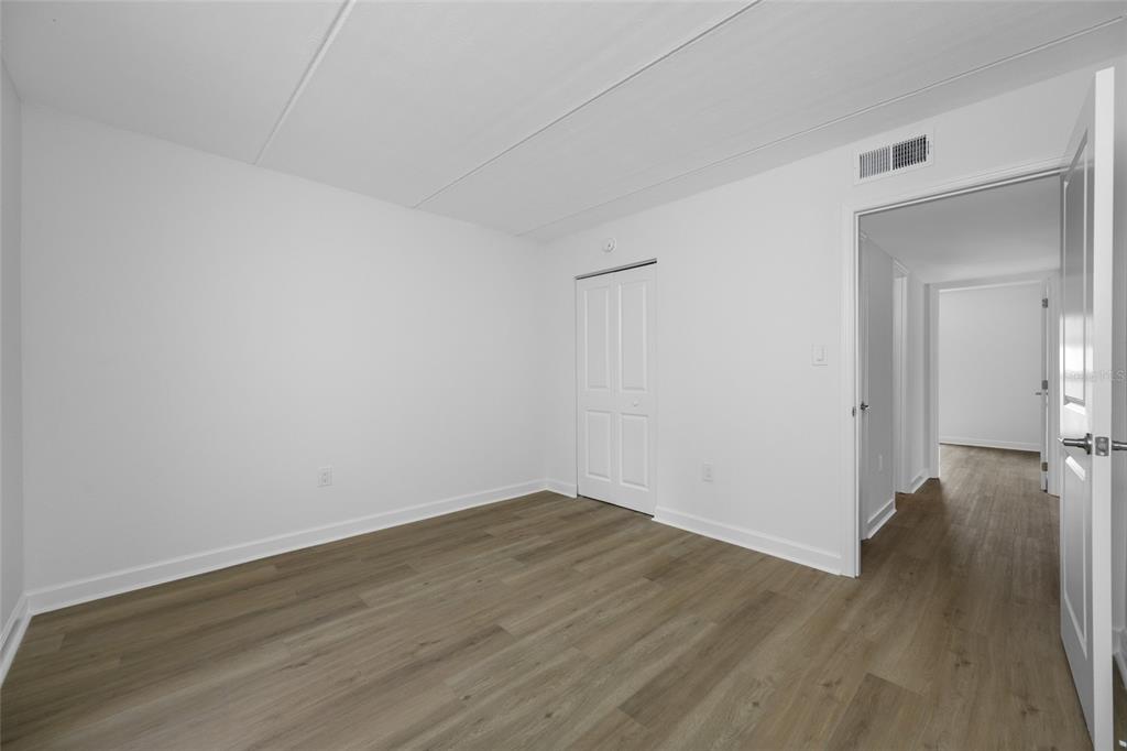 8911 Blind Pass Road, Unit 114 St. Pete Beach, FL 33706 - Photo 24 of 43 a view of a room with wooden floor and a bathroom